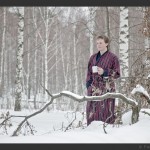 мужчина в халате на природе зимой вокруг снег с чашкой кофе